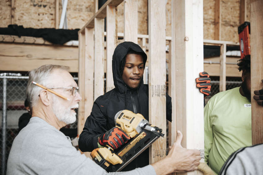 Men building framing a wall